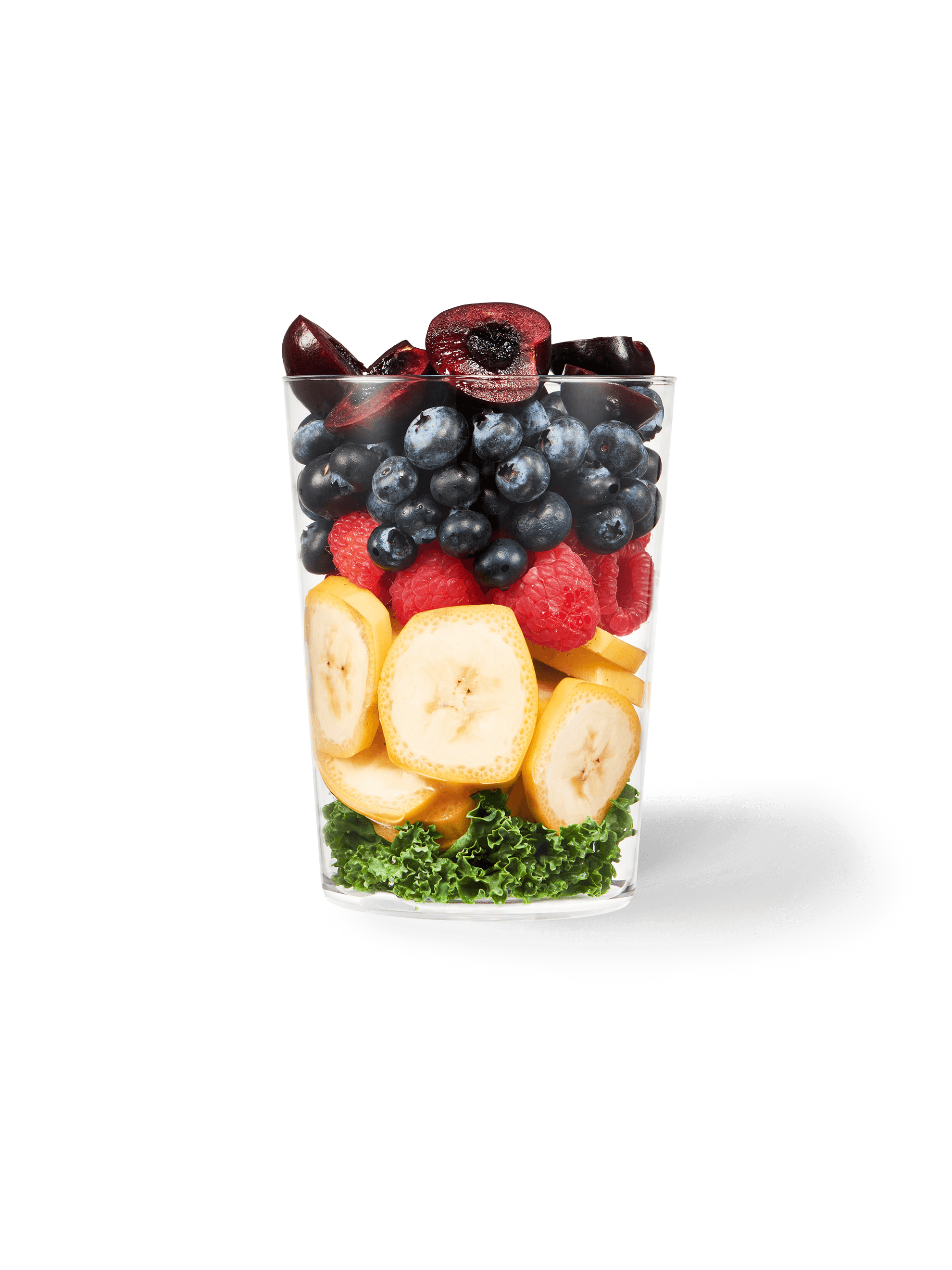 A clear cup filled with the ingredients included in our Daily Harvest Acai + Cherry Smoothie.