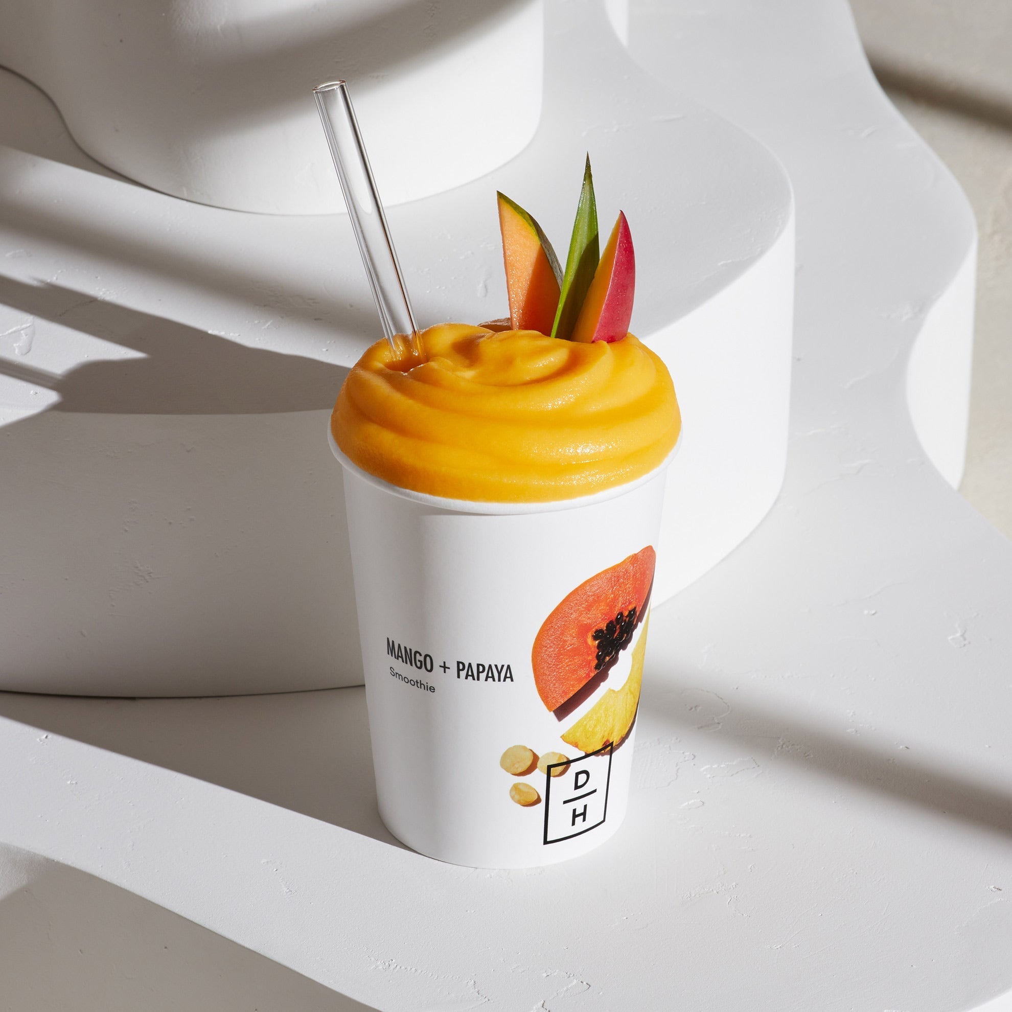 Daily Harvest Mango + Papaya Smoothie prepared in a cup with garnish.