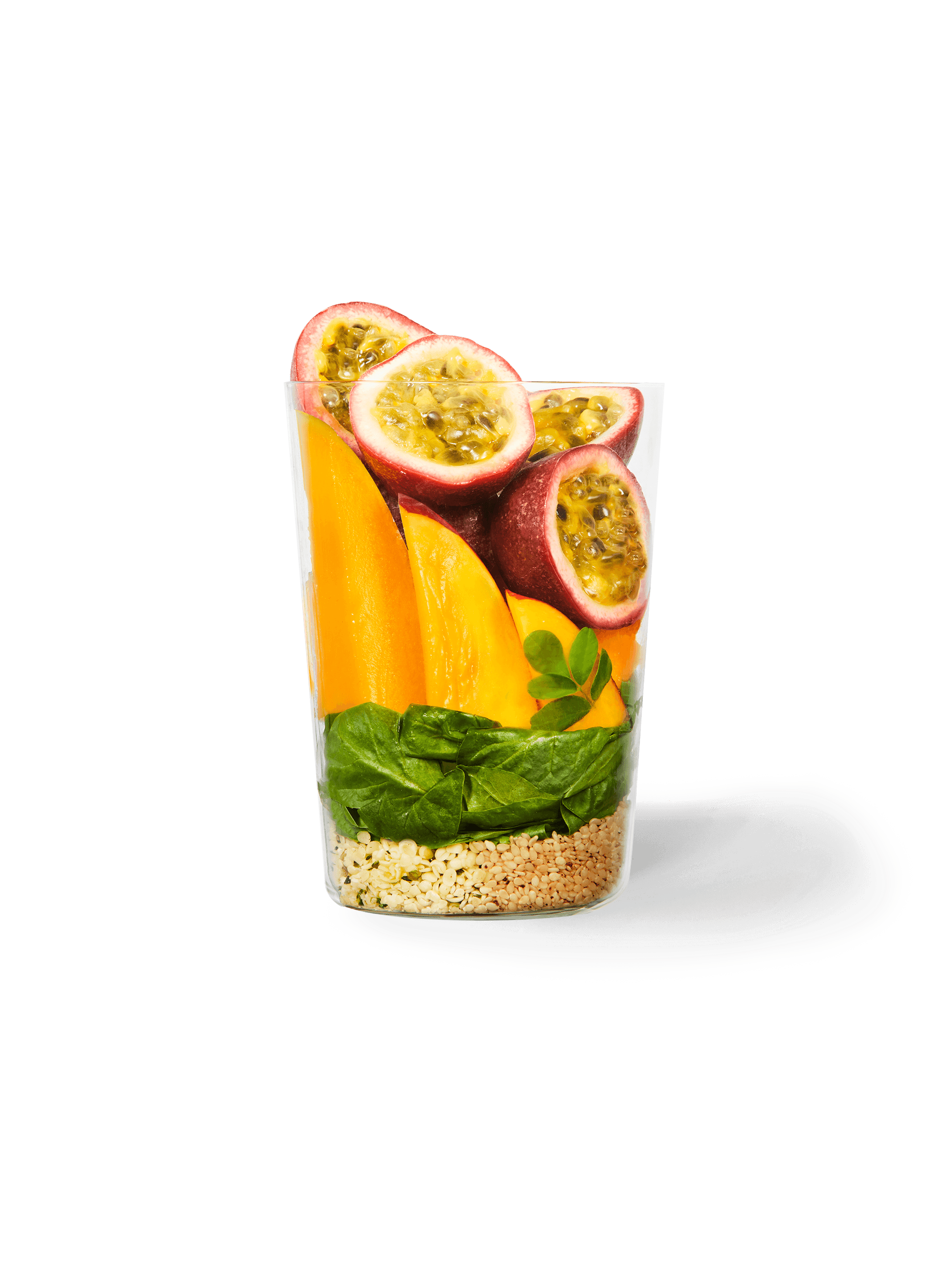 Clear cup filled with the ingredients included in our Passion Fruit + Greens Smoothie