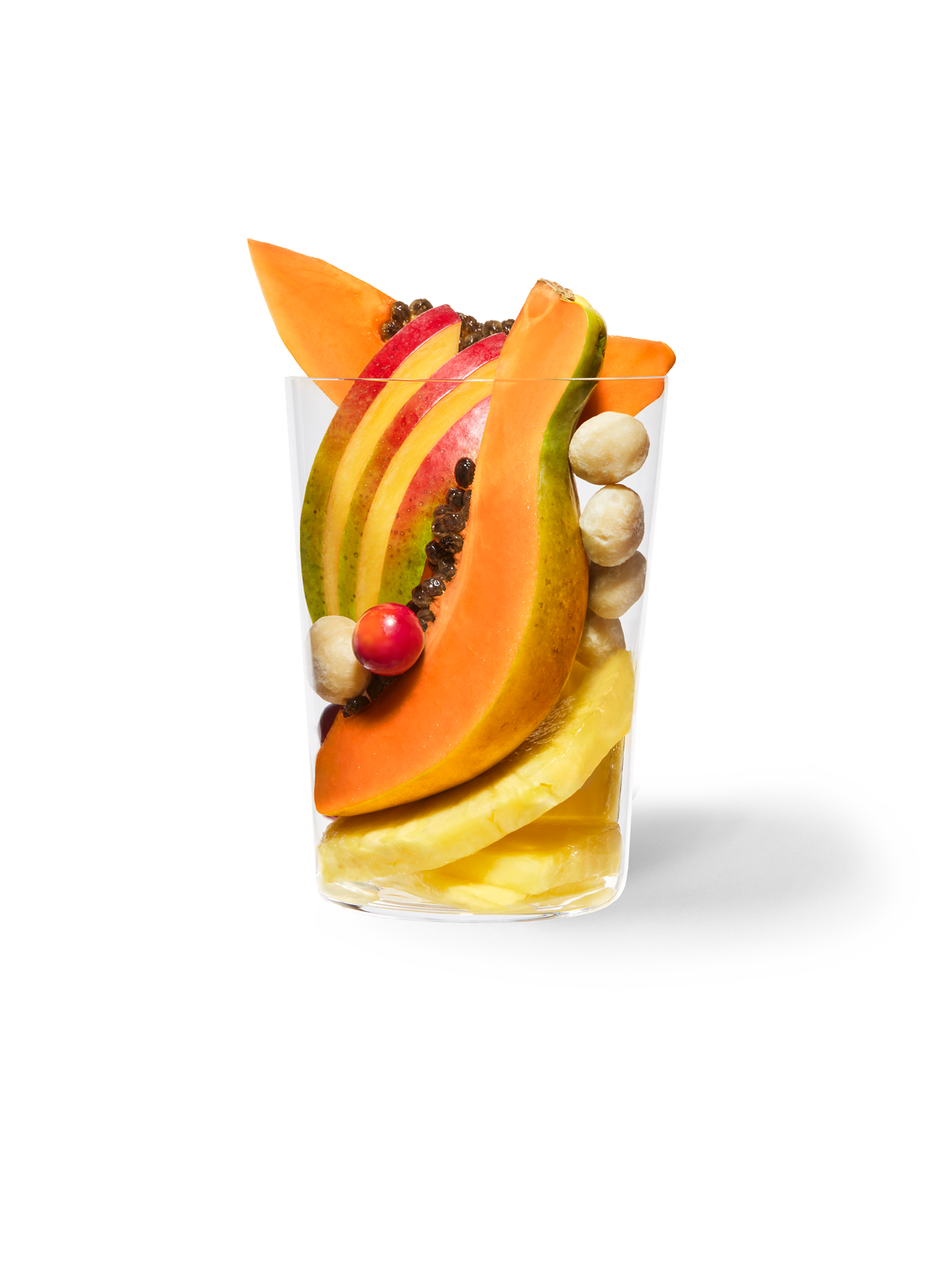 Clear cup filled with the ingredients included in our Daily Harvest Mango + Papaya Smoothie.