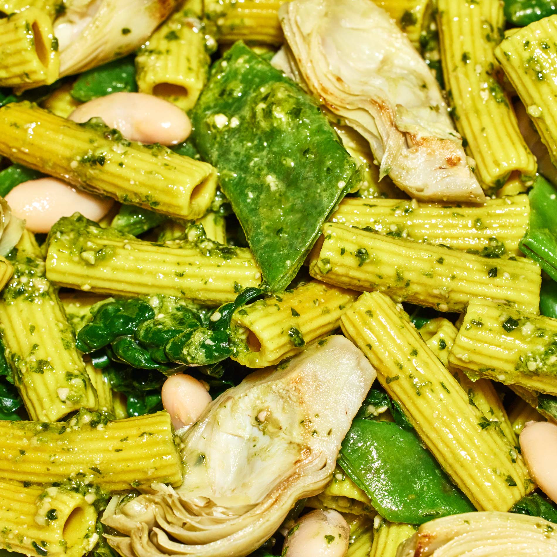 A close-up shot of the White Bean + Spinach Pesto Pasta prepared.