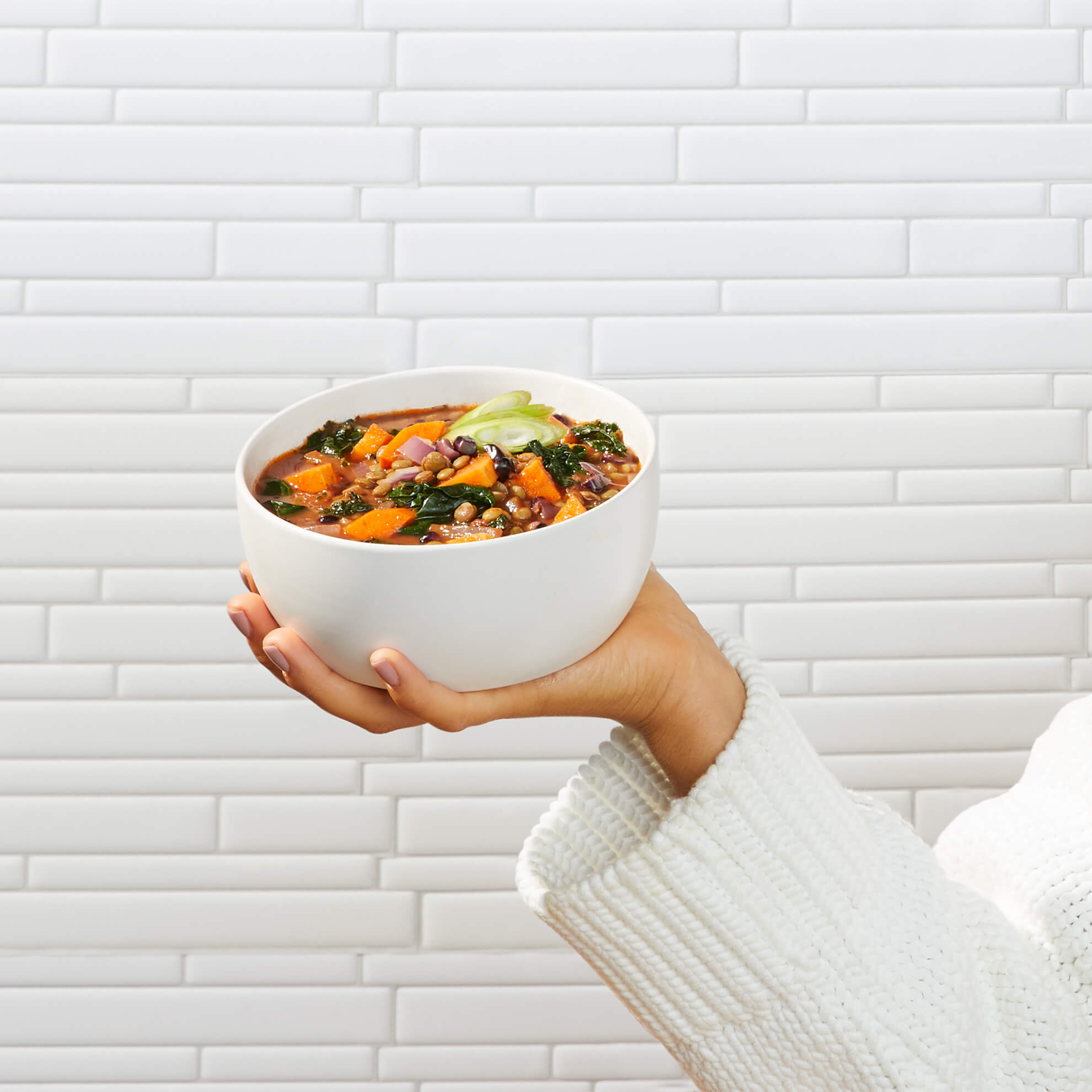 Lifestyle image of Daily Harvest Lentil + Mesquite Soup prepared in a bowl.