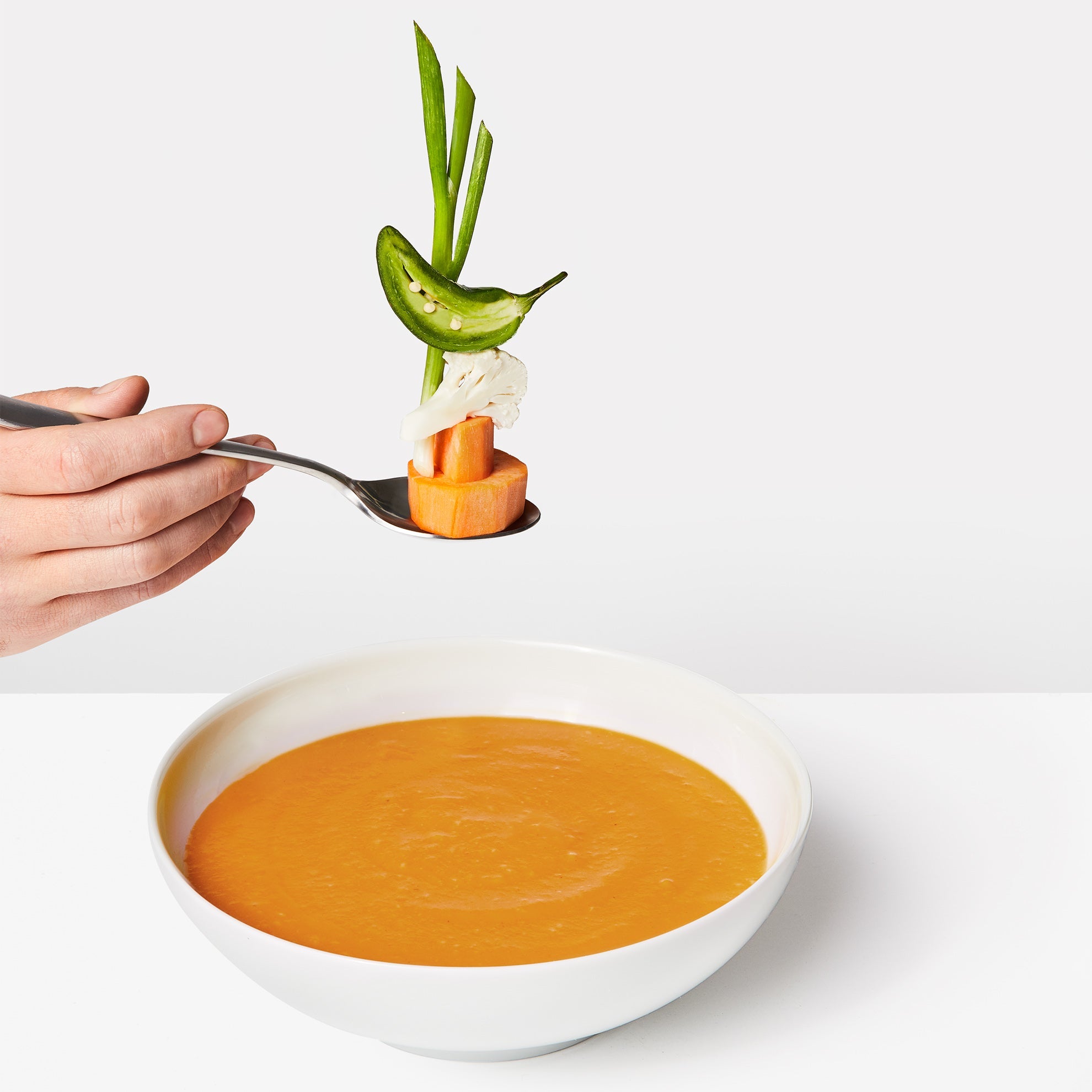Lifestyle image of Daily Harvest Sweet Potato + Miso Soup in a bowl with ingredients included.