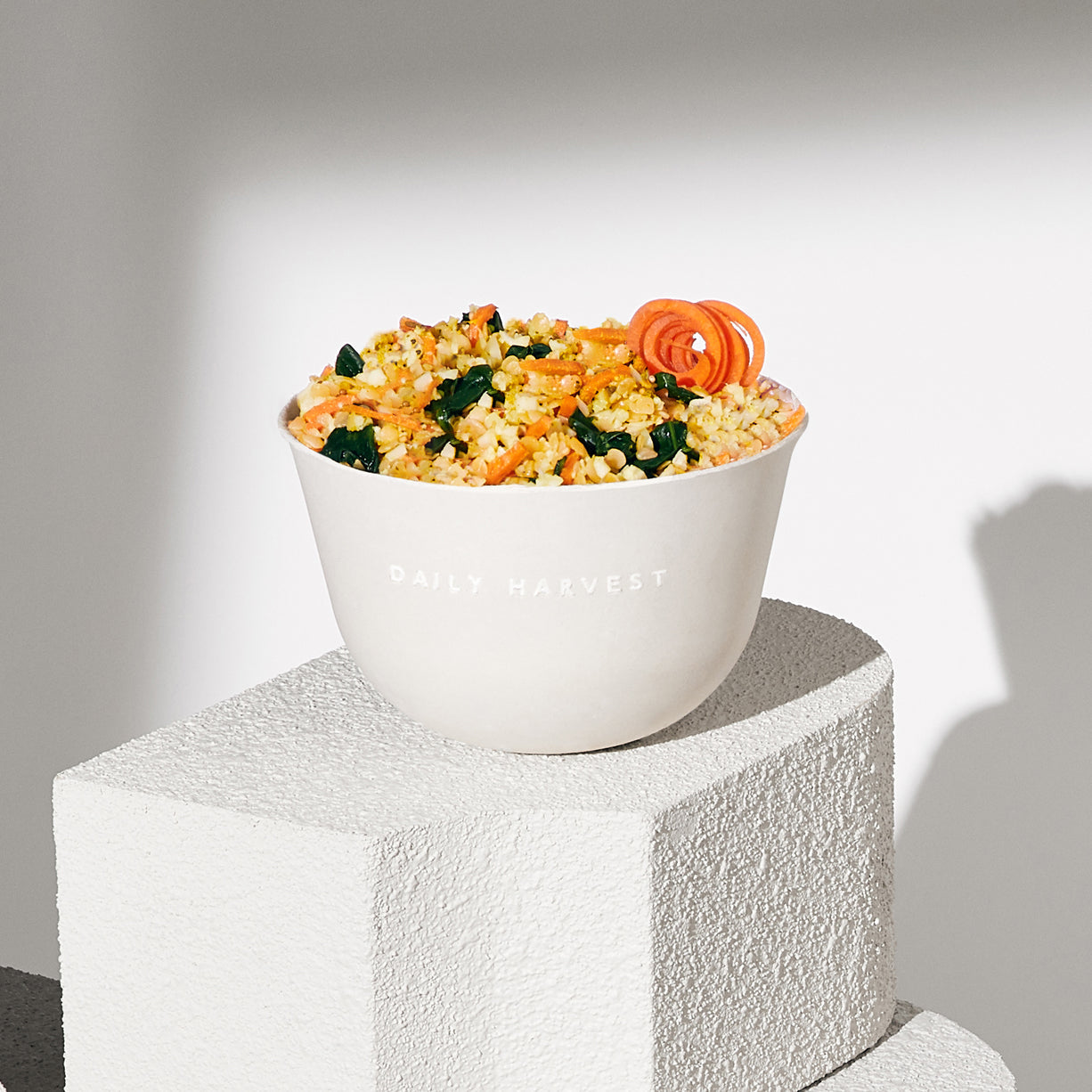 A lifestyle image of Daily Harvest Red Lentil + Cumin Harvest Bowl prepared in a bowl.