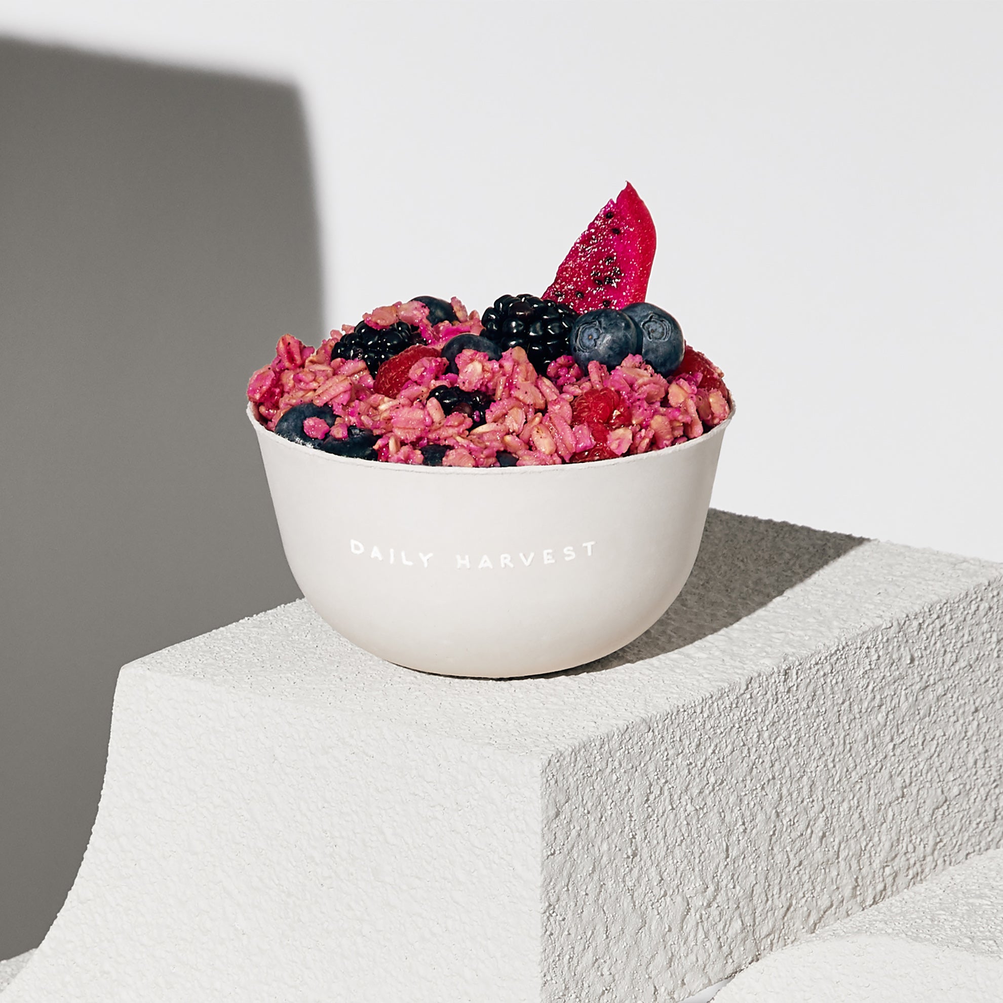 Image of Daily Harvest Mulberry + Dragon Fruit Oat Bowl prepared with garnish. 