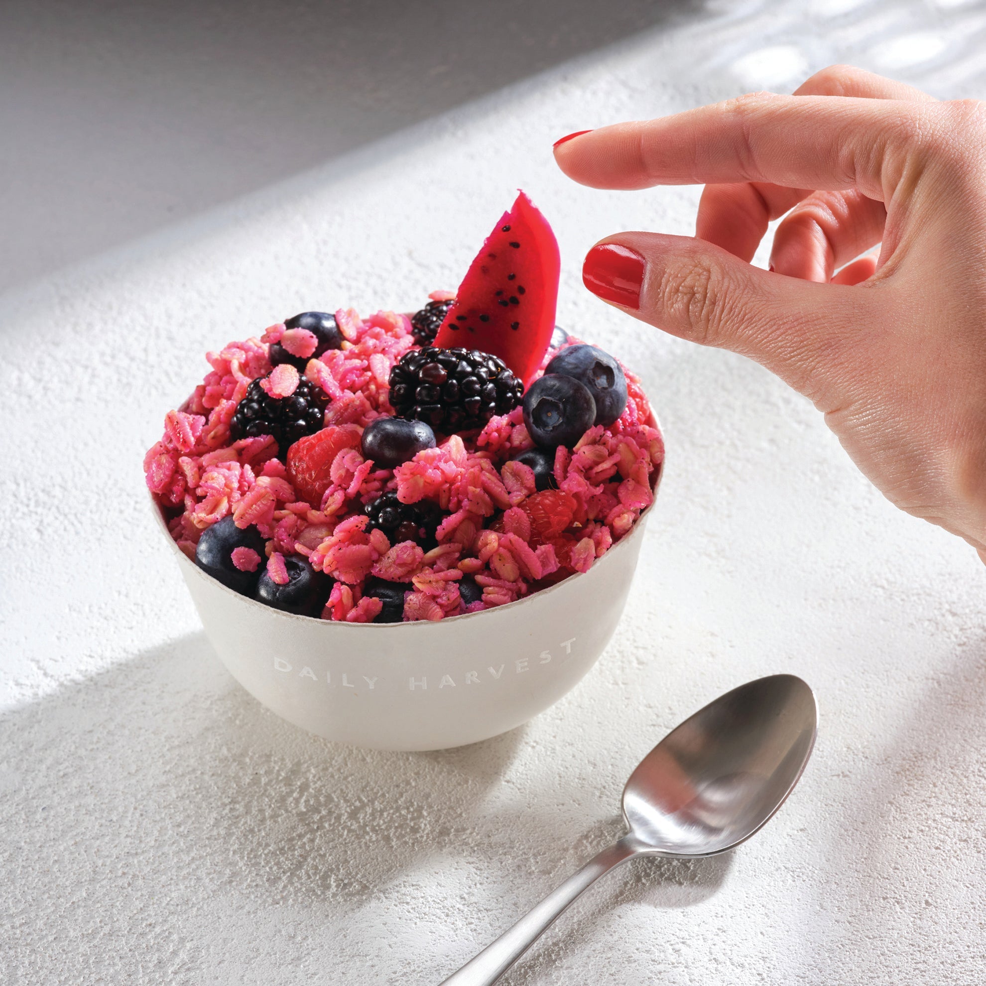 Daily Harvest Mulberry + Dragon Fruit Oat Bowl prepared with garnish. 