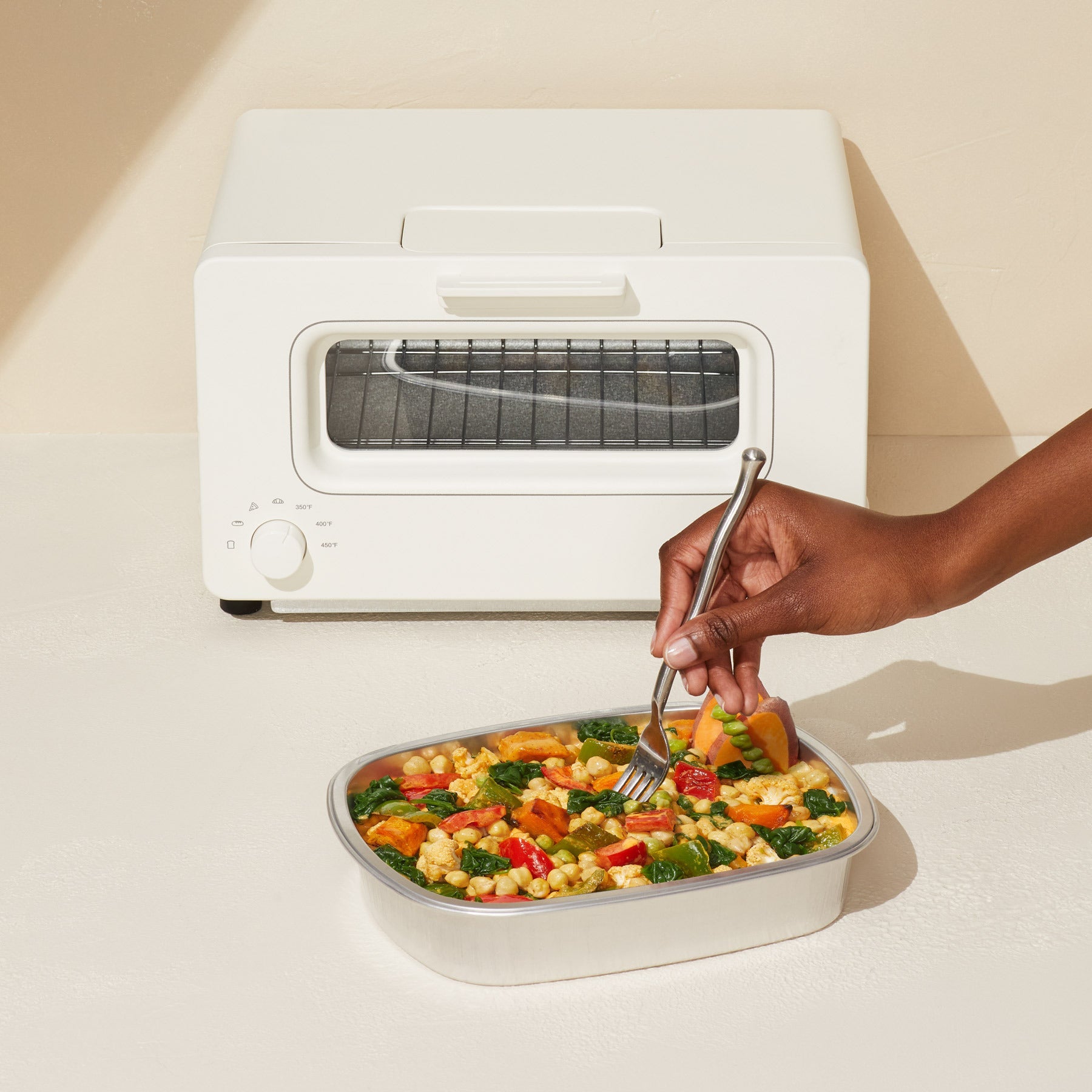 Image of a harvest bake in the aluminium container sitting next to an oven.