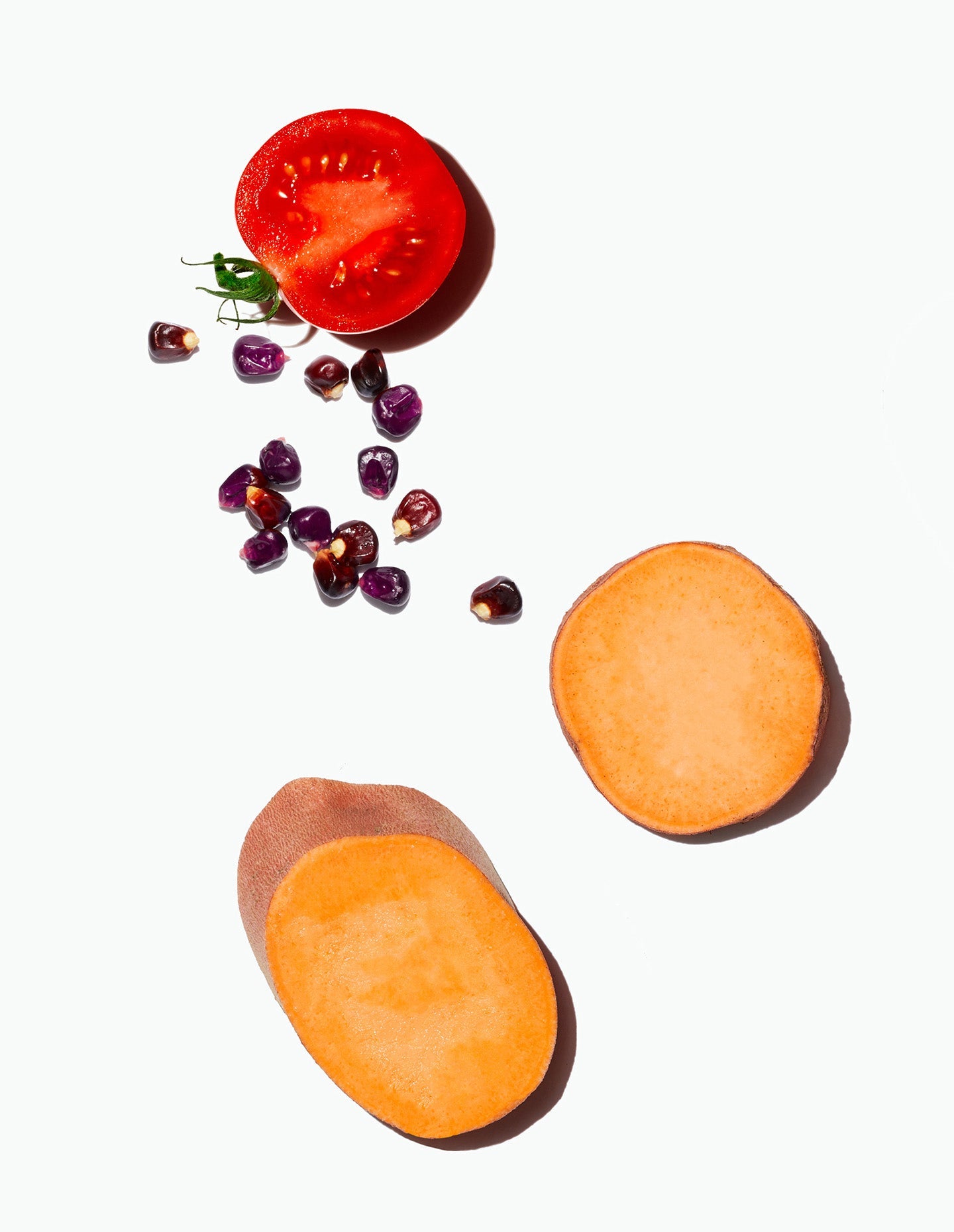 Image of Daily Harvest Lentil + Mesquite Chili Soup, including sliced sweet potatoes, a halved tomato, and purple corn.