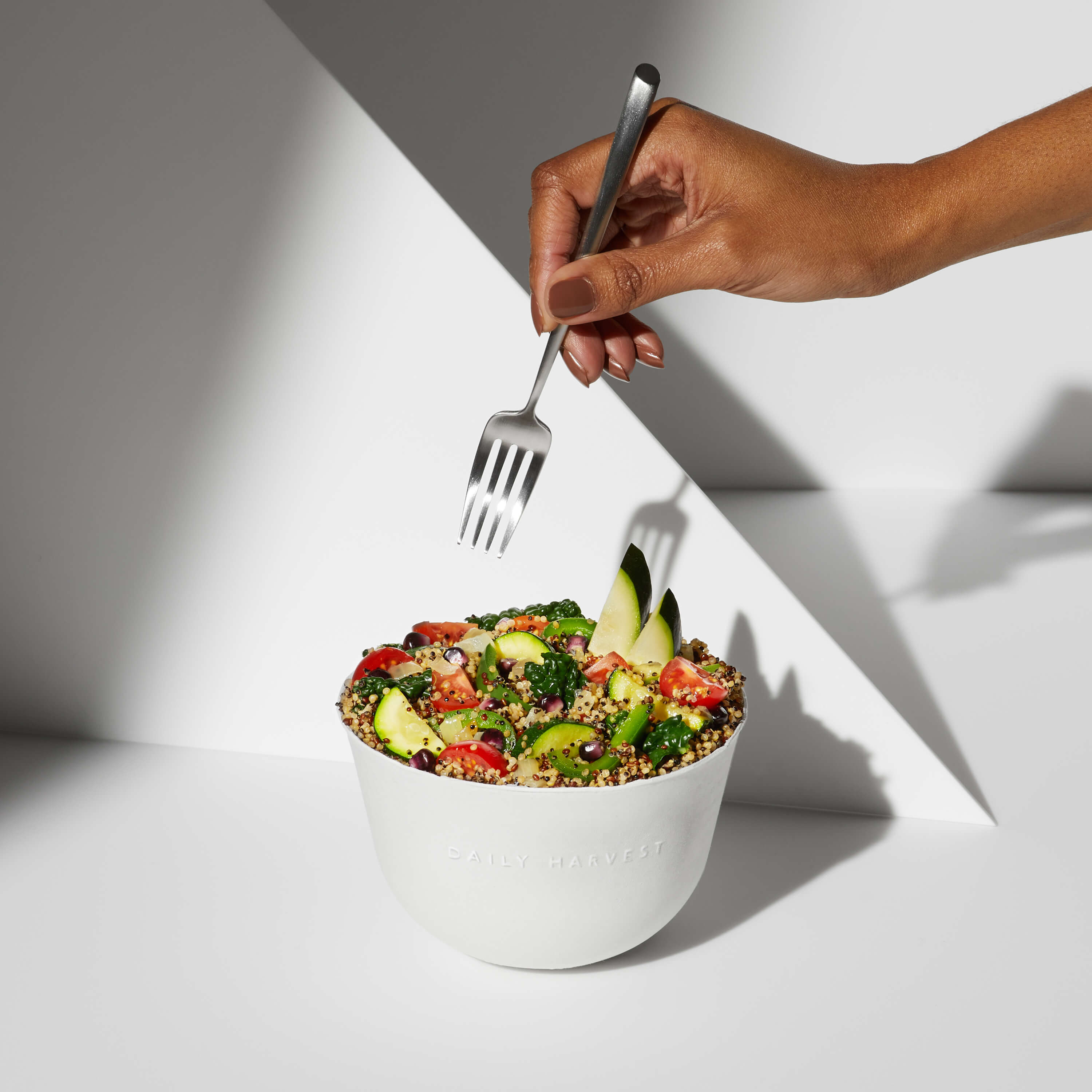A lifestyle image of a prepared Daily Harvest Quinoa + Chipotle Harvest Bowl in a bowl.