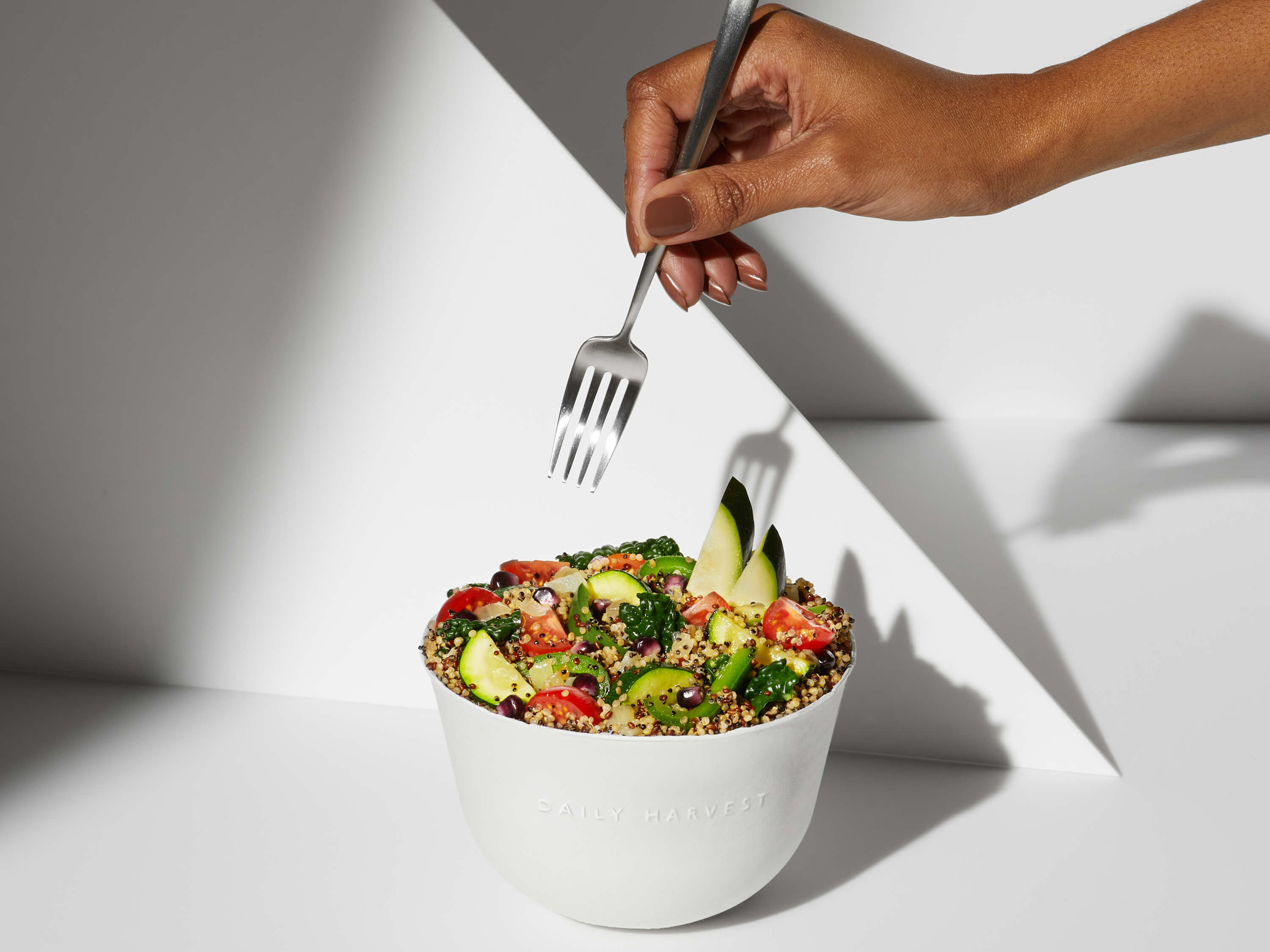 A lifestyle image of a prepared Daily Harvest Quinoa + Chipotle Harvest Bowl in a bowl.