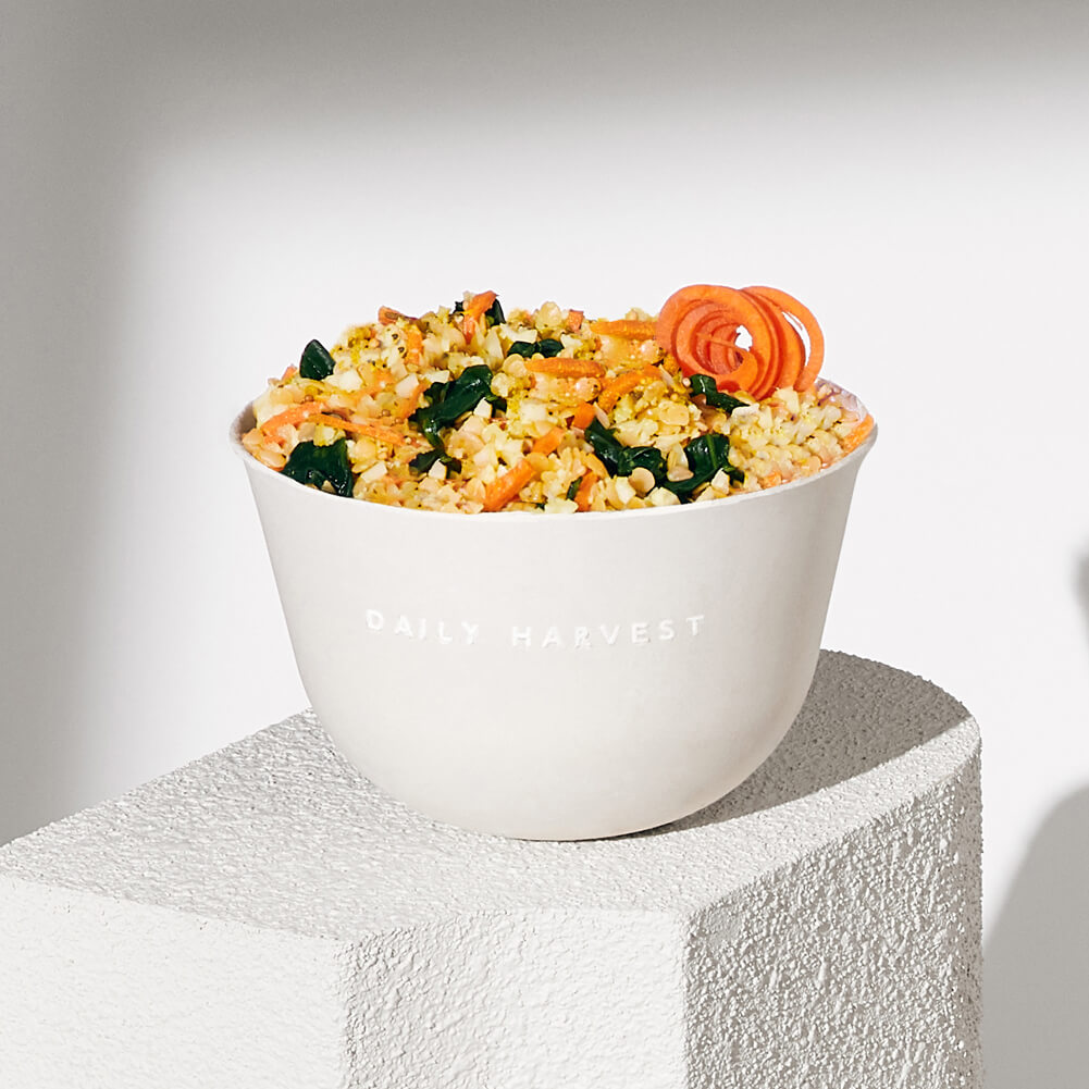 A lifestyle image of Daily Harvest Red Lentil + Cumin Harvest Bowl prepared in a bowl.
