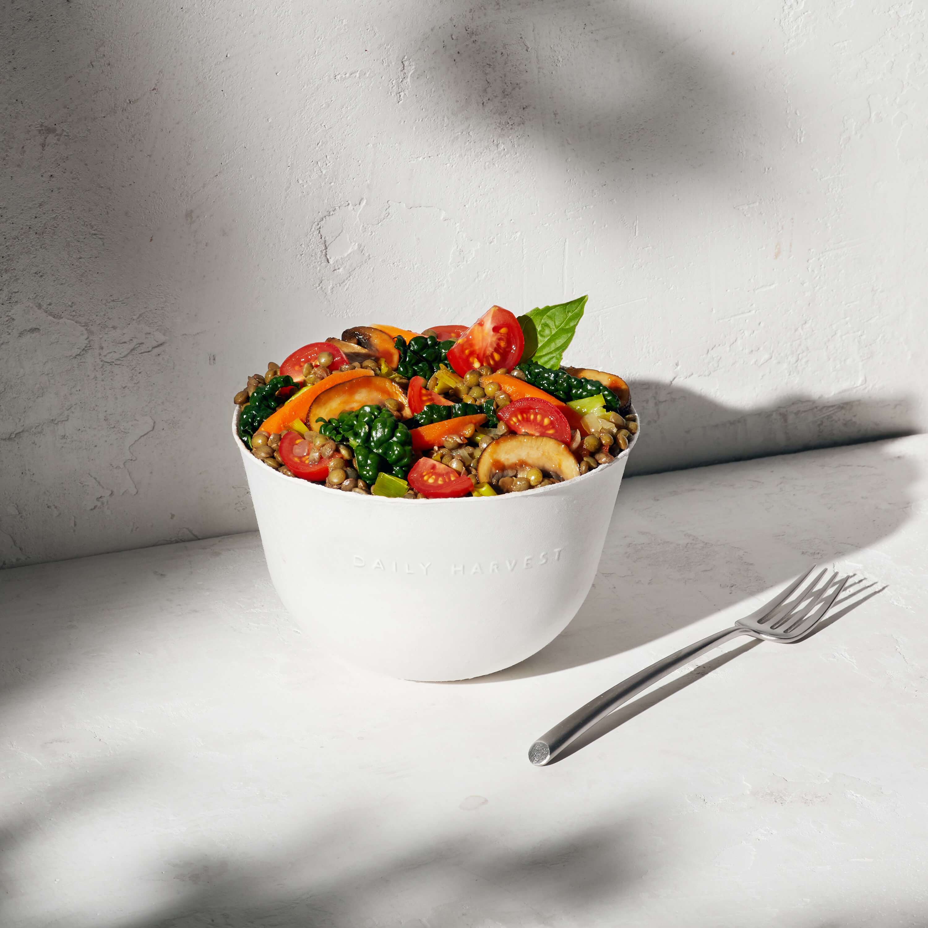 Lentil + Tomato Bolognese Harvest Bowl prepared in a bowl with garnish