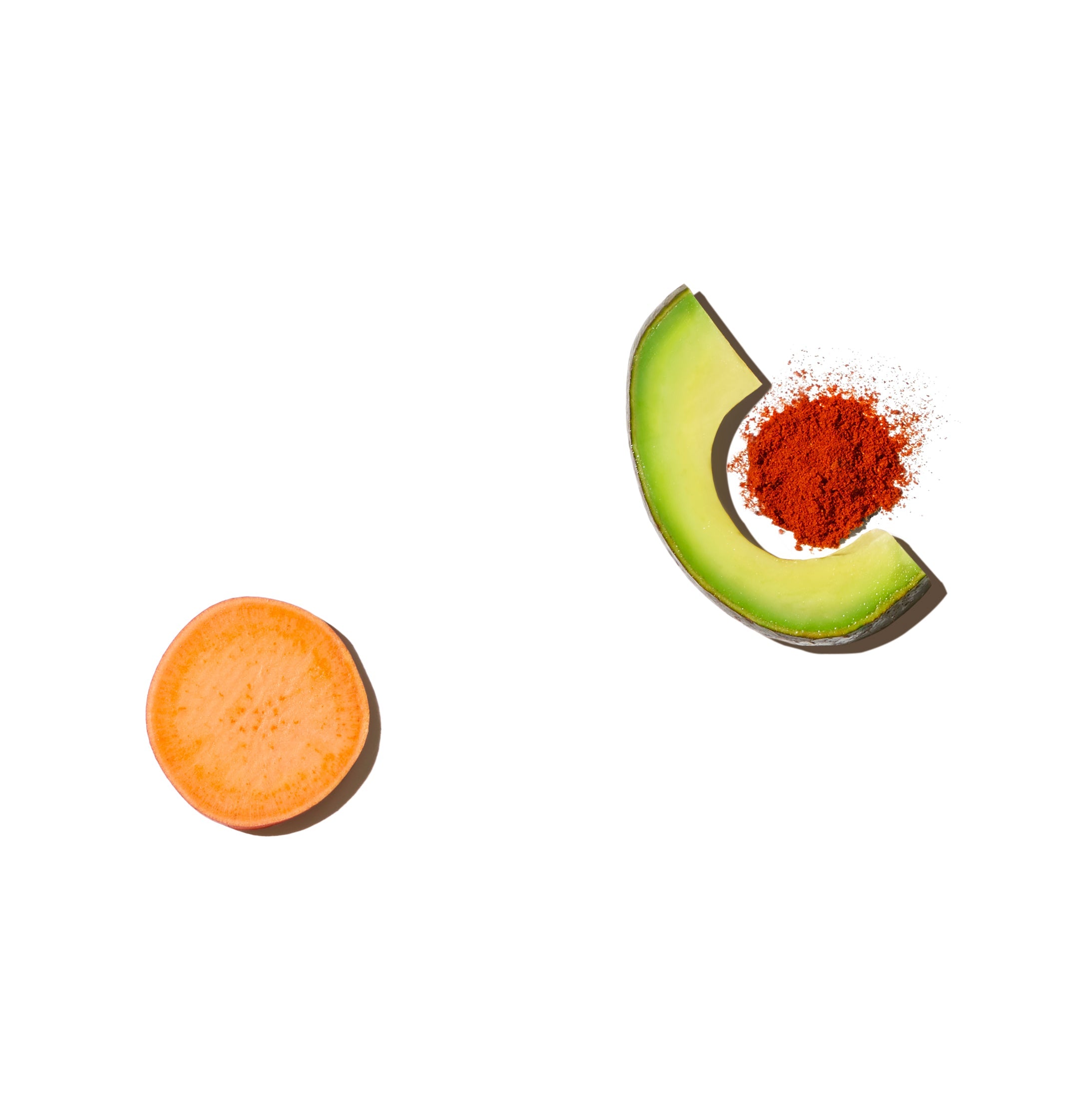 a sweet potato, an avocado slice, and a pile of paprika