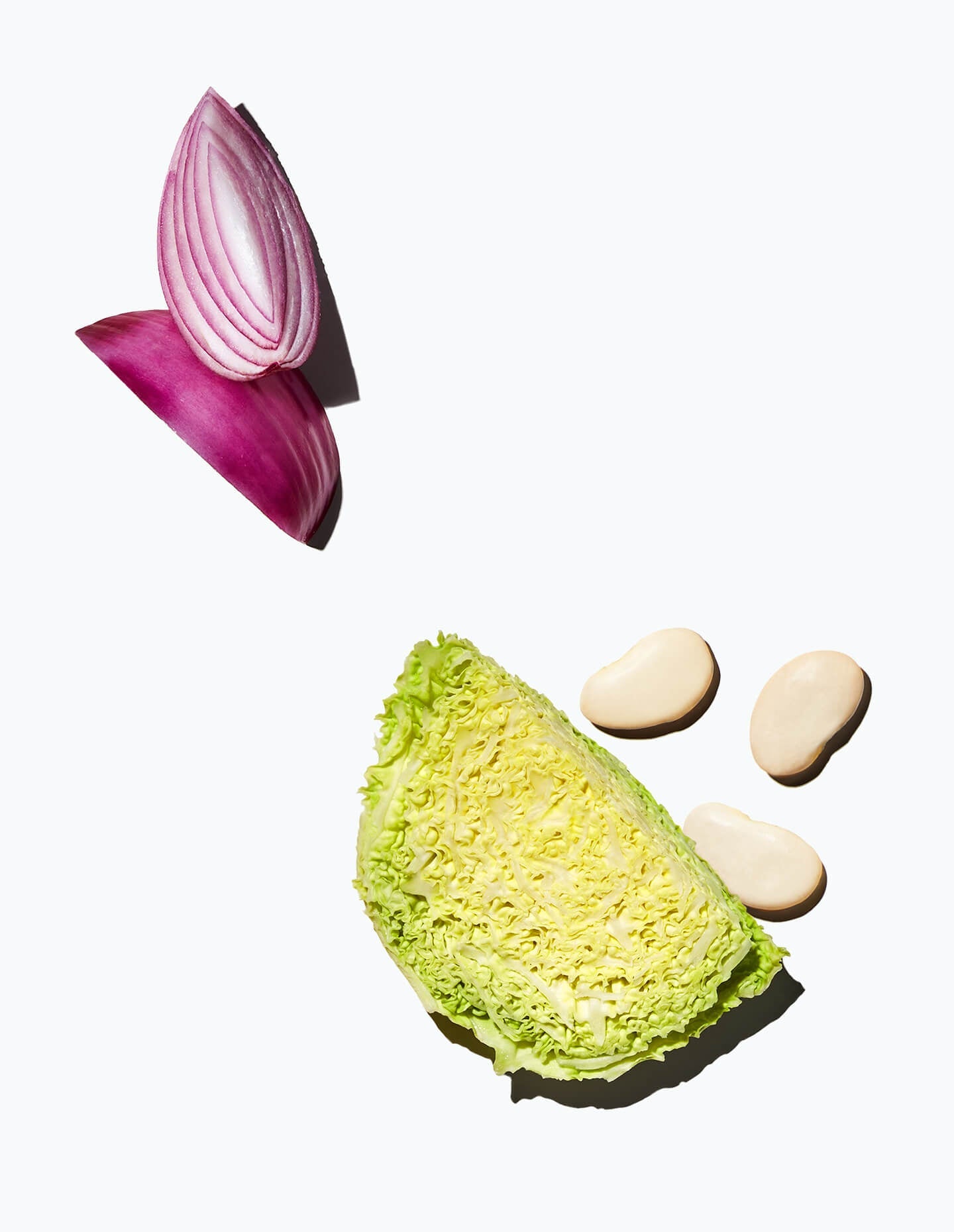 Gigante beans, pieces of red onions, and a chunk of savoy cabbage