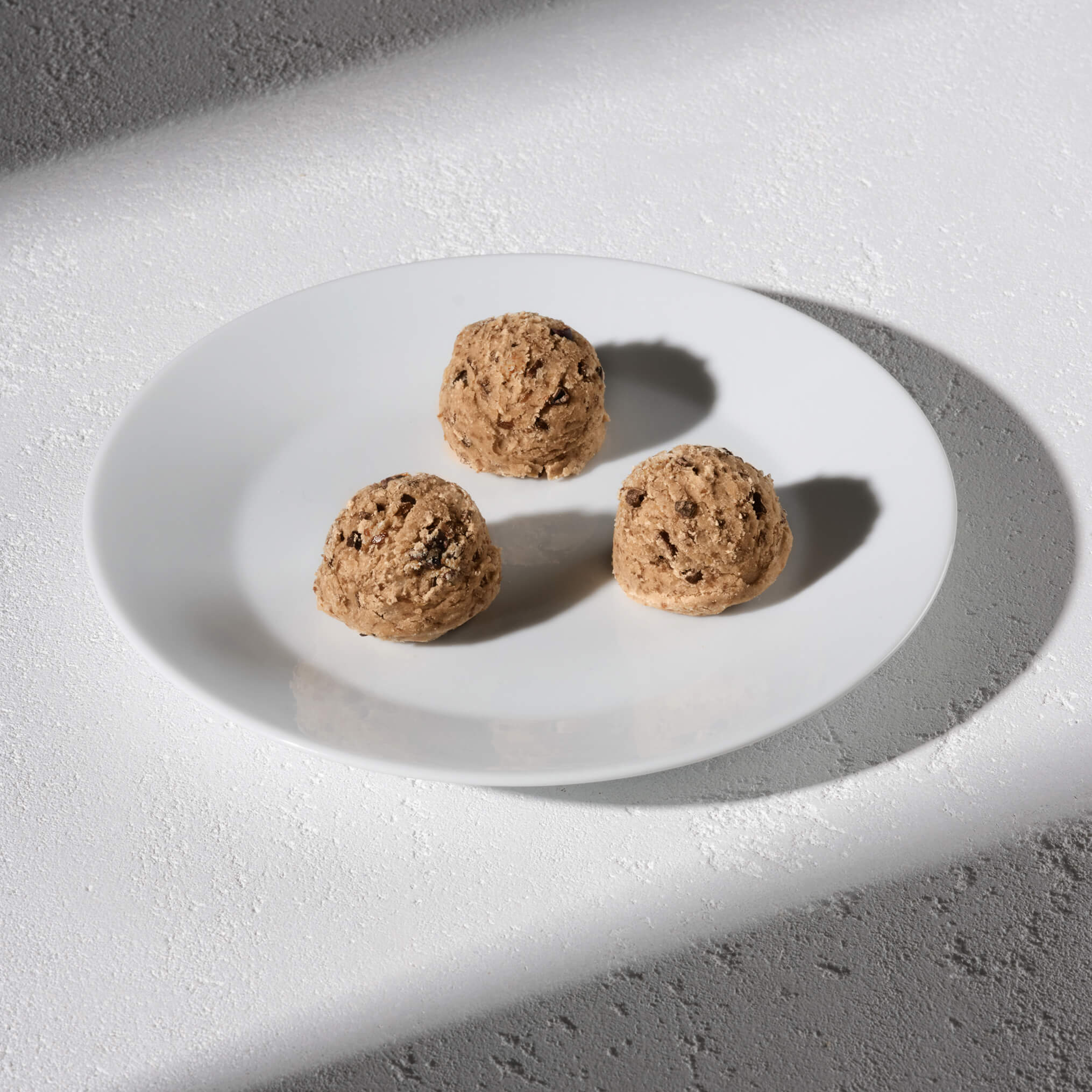 Lifestyle image of Daily Harvest Cacao Nib + Vanilla bites prepared on a plate.