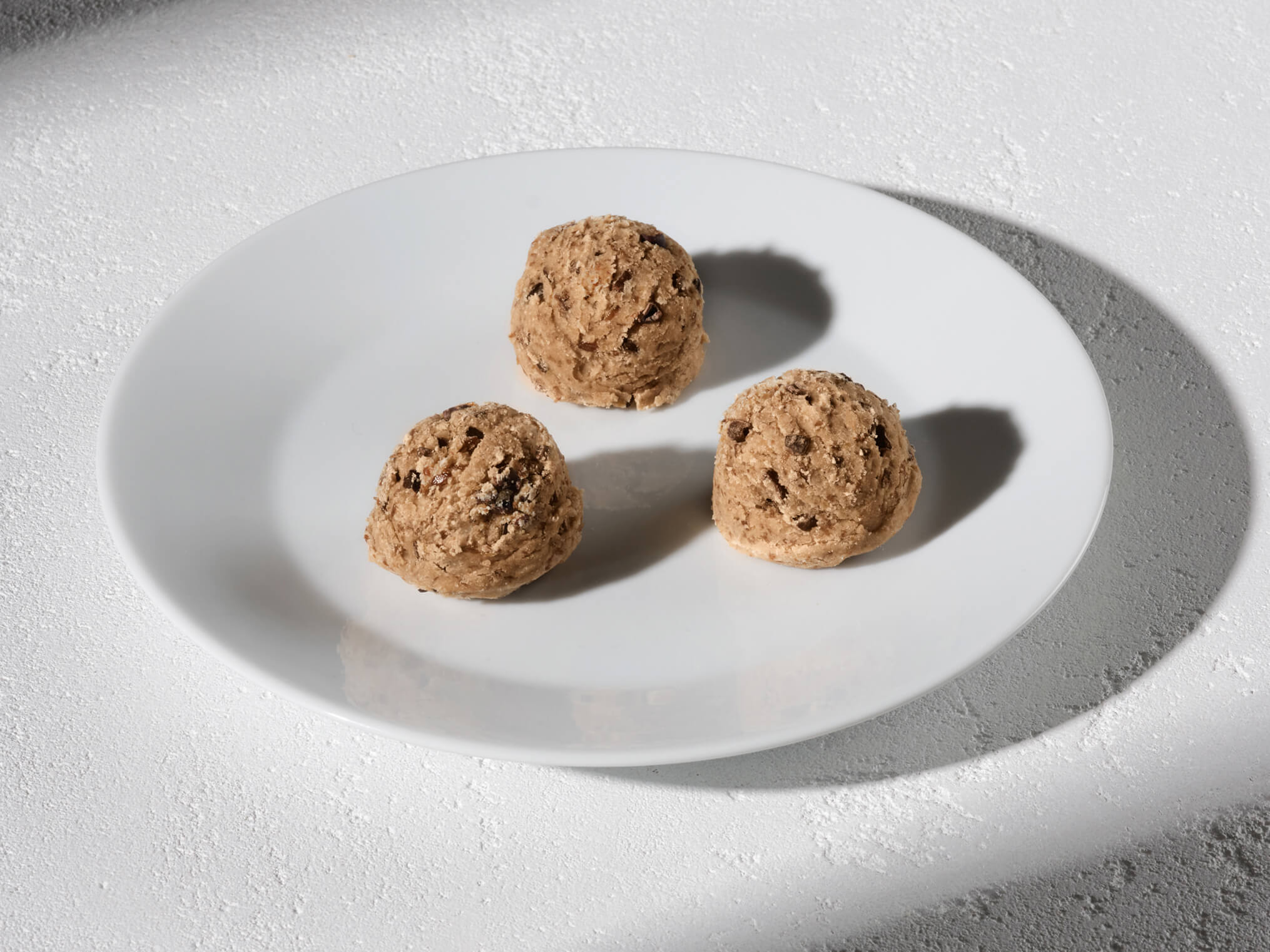 Lifestyle image of Daily Harvest Cacao Nib + Vanilla Bites prepared on a plate.