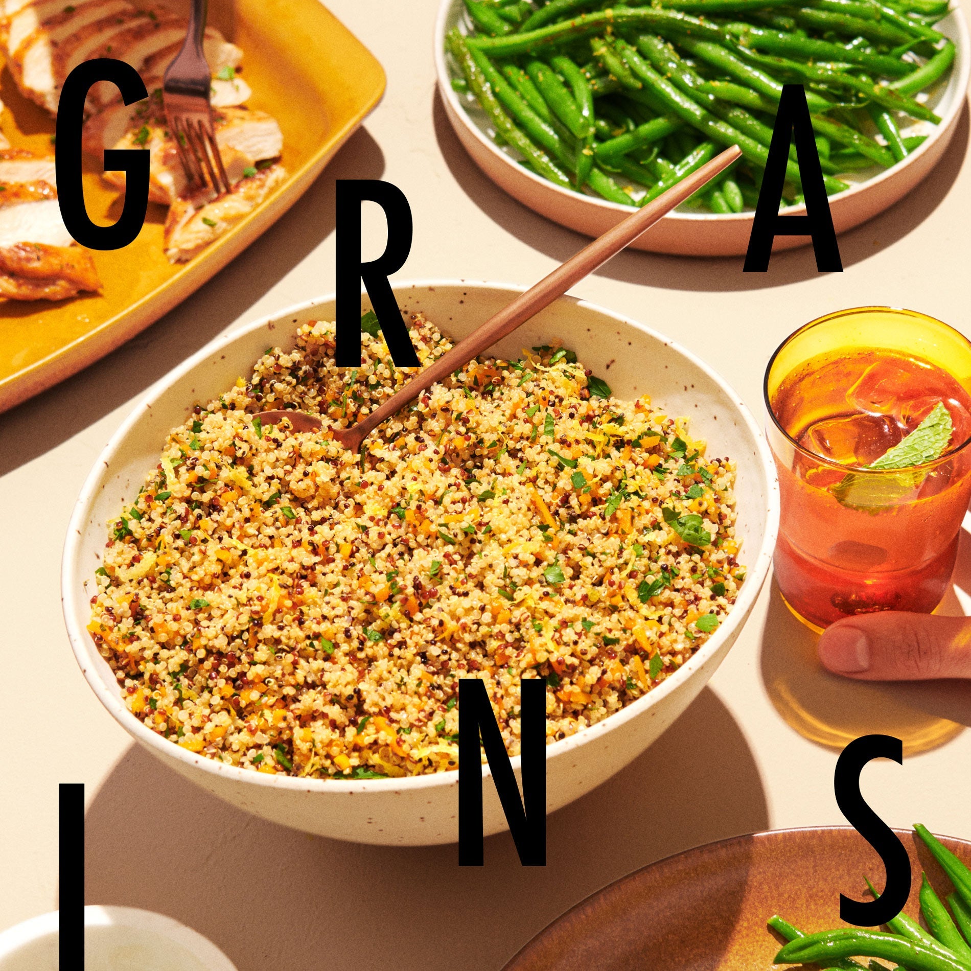 A bowl with our prepared lemon quinoa and butternut squash beside a plate of green beans.