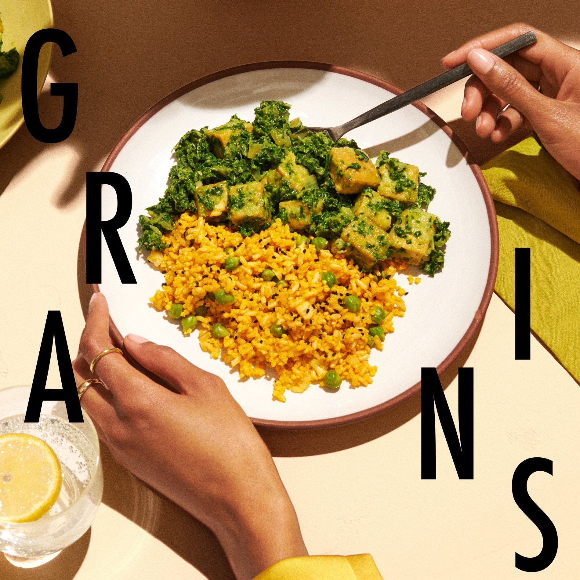 A plate with our Curried Brown Rice and Green Chickpea prepared on it alongside curried tofu.