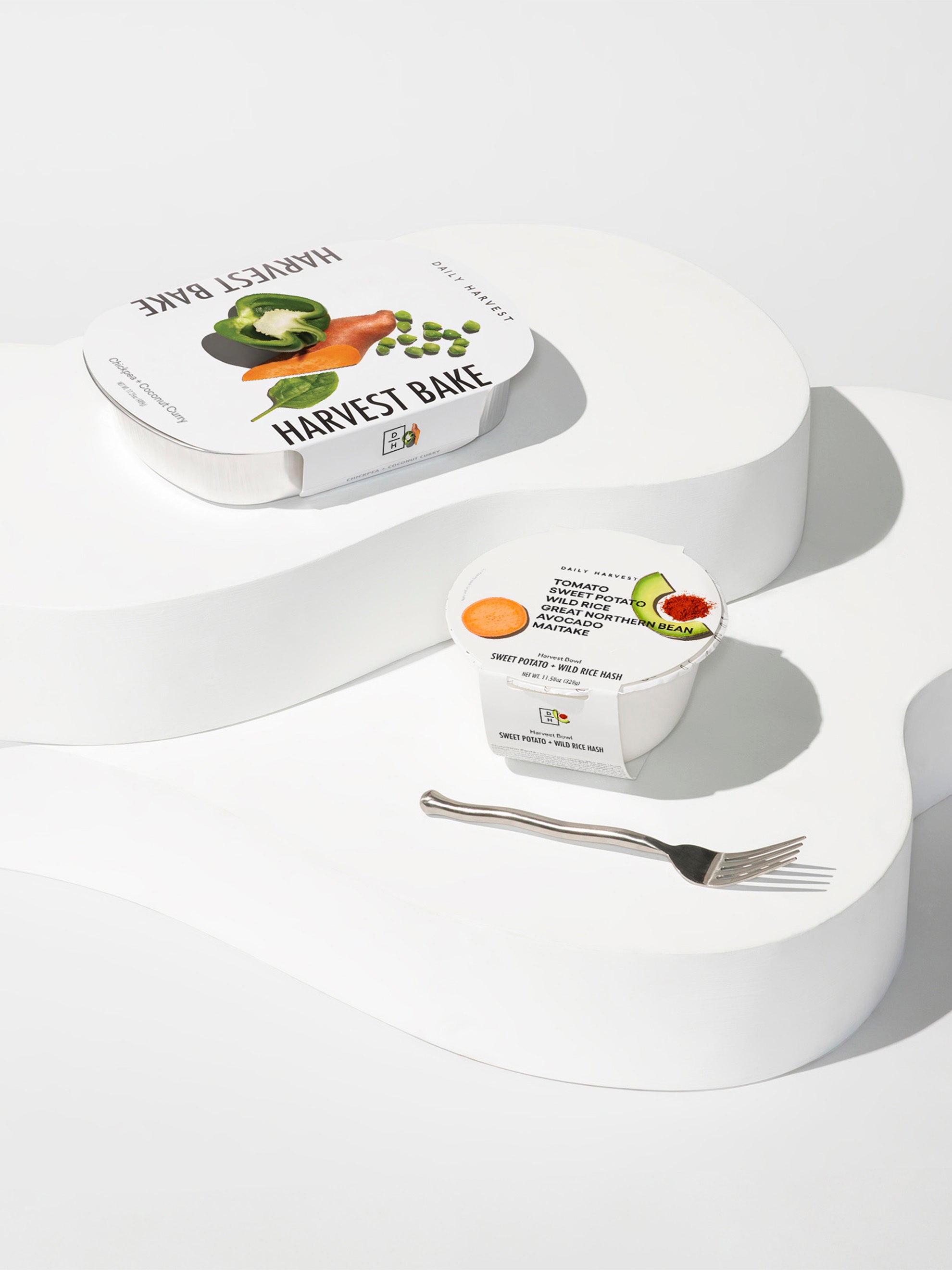 Image of a harvest bake in packaging sitting next to a harvest bowl in packaging to show the size difference.