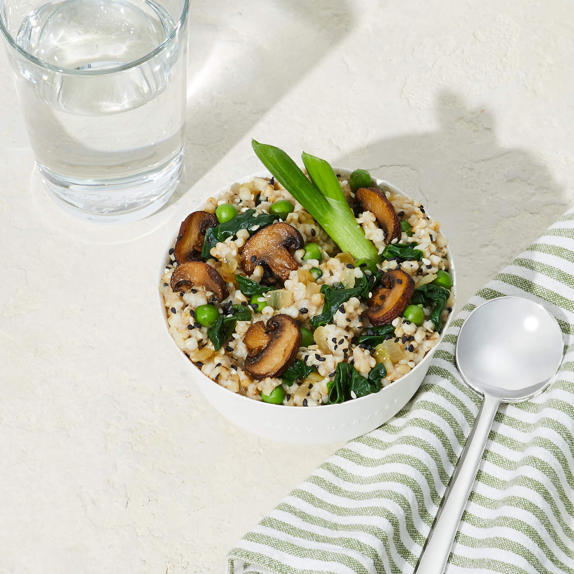 Overhead lifestyle image of Daily Harvest Cremini + Miso Oat Forager Bowl prepared in a bowl.